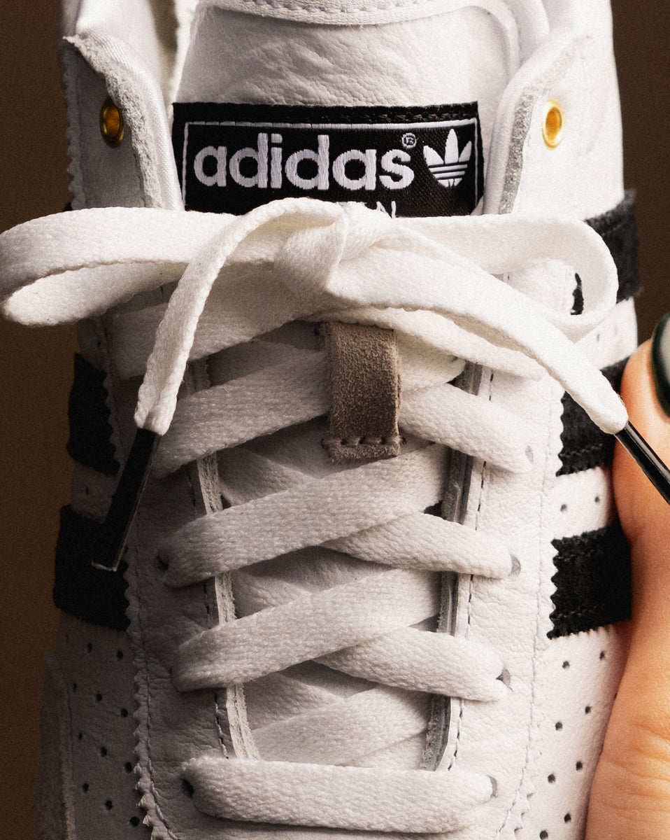 Adidas originals black and gold superstar low top sneaker best sale